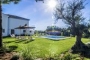 The house is surrounded by flower beds 